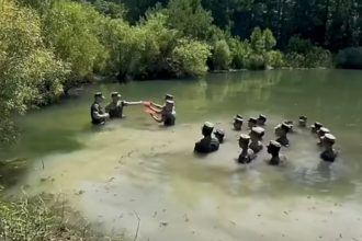 Watch these Marines reenlist in a chest-deep swamp
