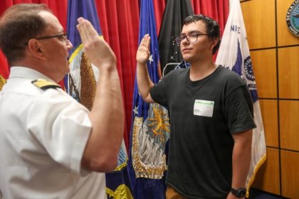 Navy captain gives oath of enlistment to son on last day of service